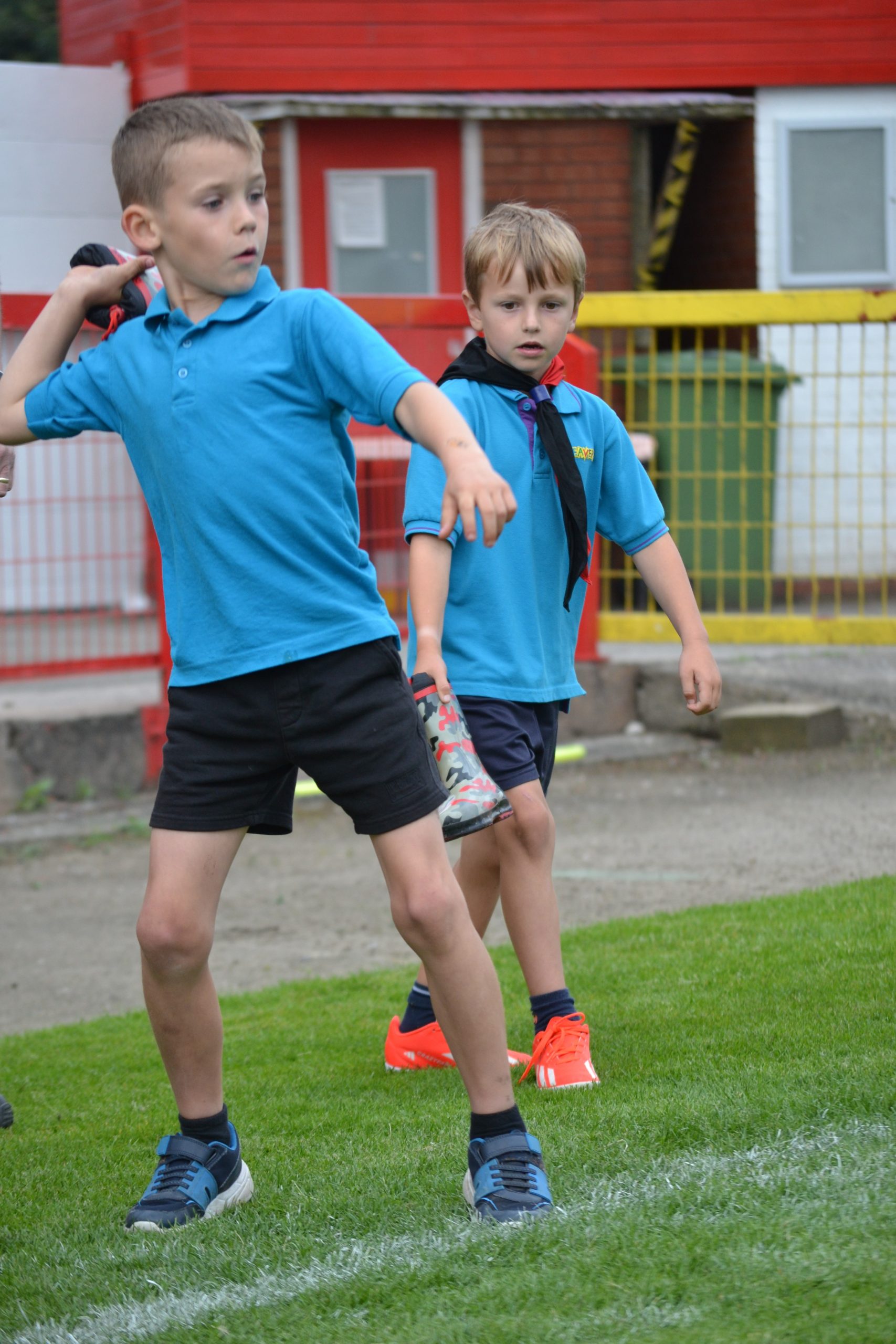 2 Beaver Scouts throwing wellington boots