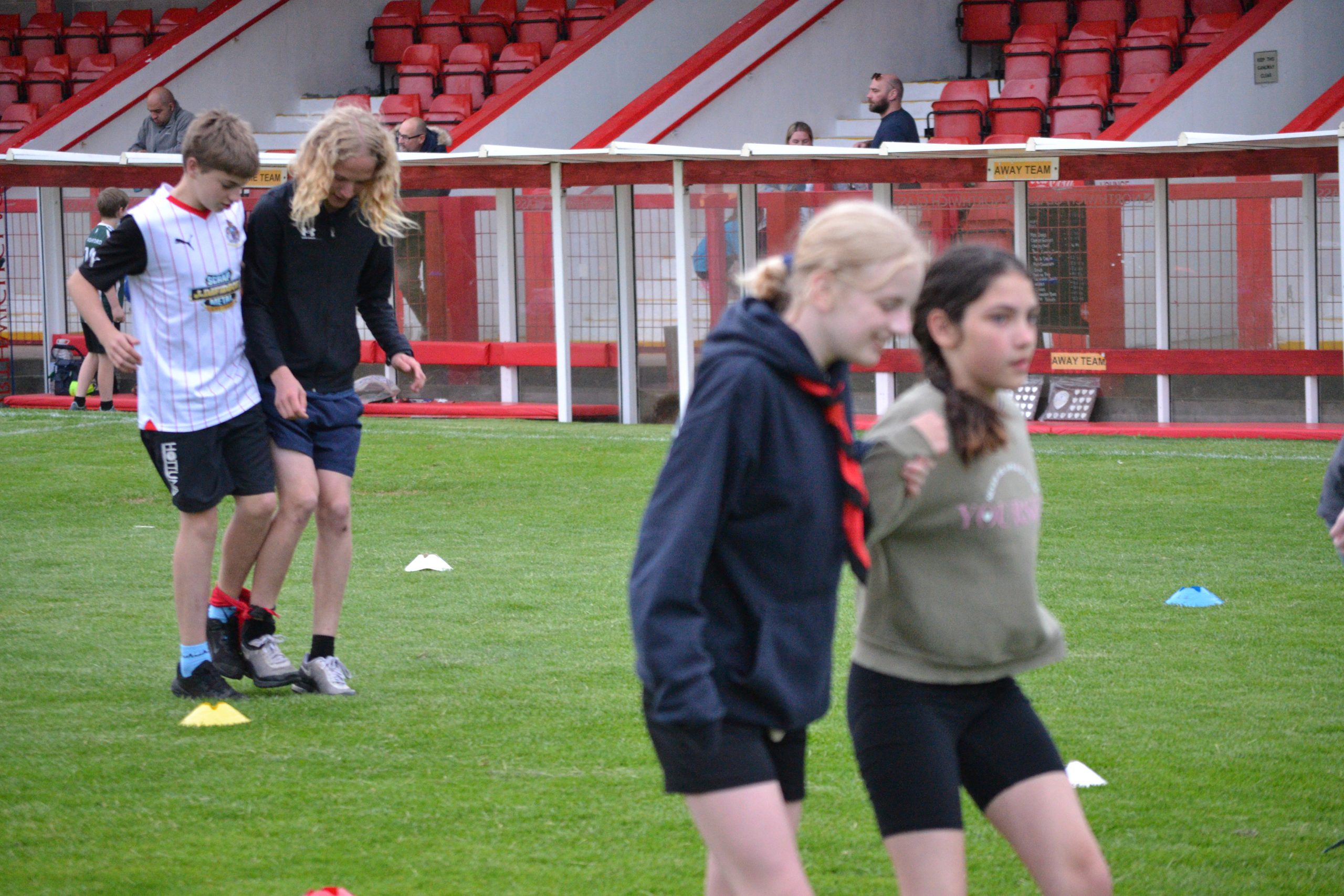 4 Scouts in pairs racing in a three legged race