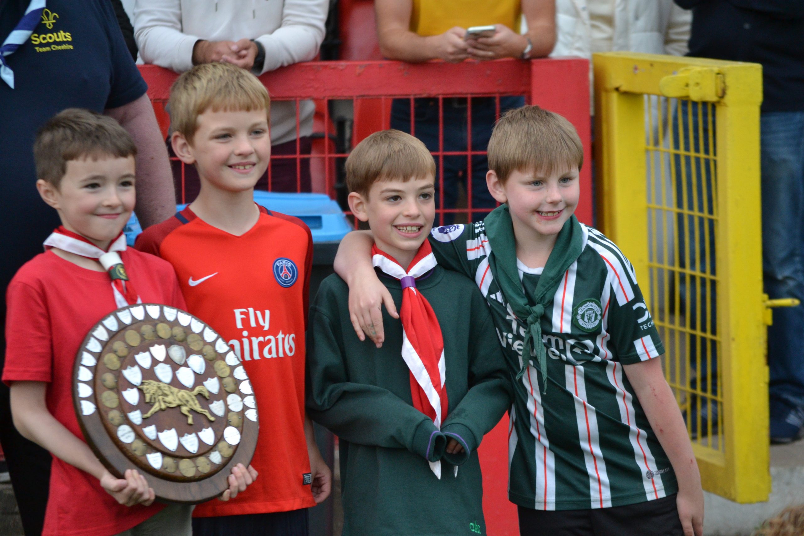 4 Cub Scouts celebrating with trophy