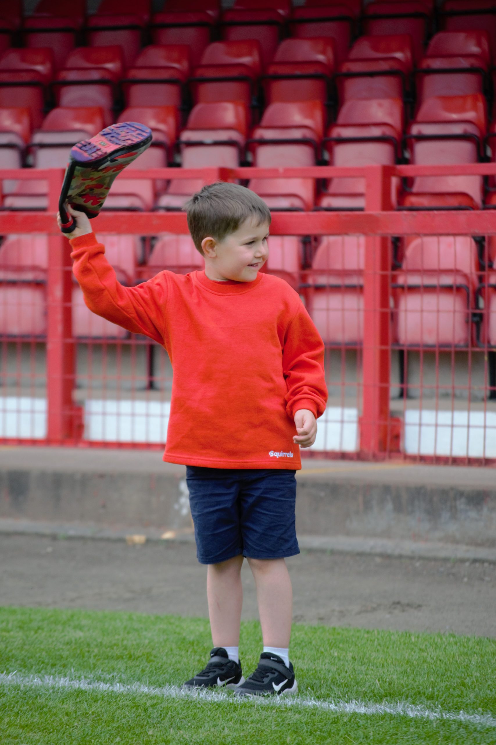 Squirrel Scout throwing a wellington boot